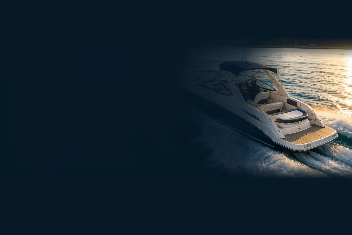 Boat owner driving a cabin cruiser across open water